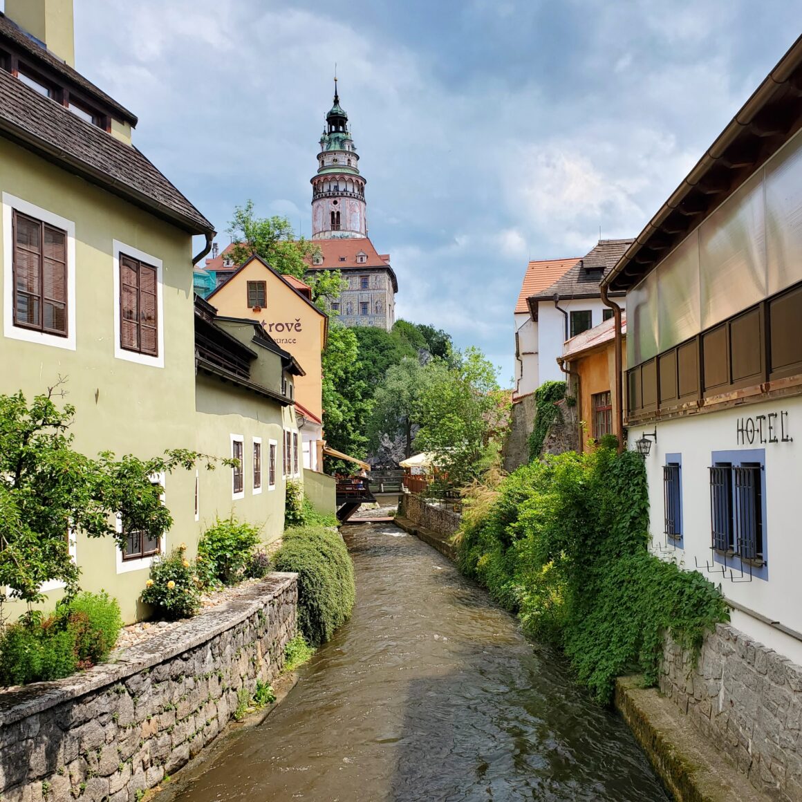 A photo of Český Krumlov along the river, with the castle in the background