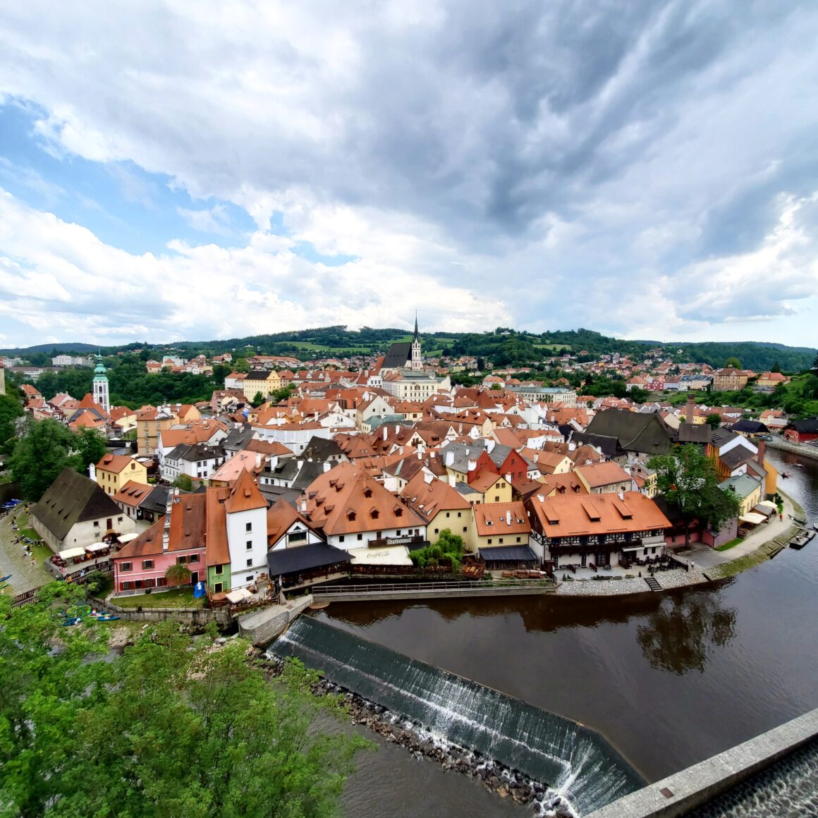 A photo of Český Krumlov from the castle grounds, with the river flowing through the downtown area.