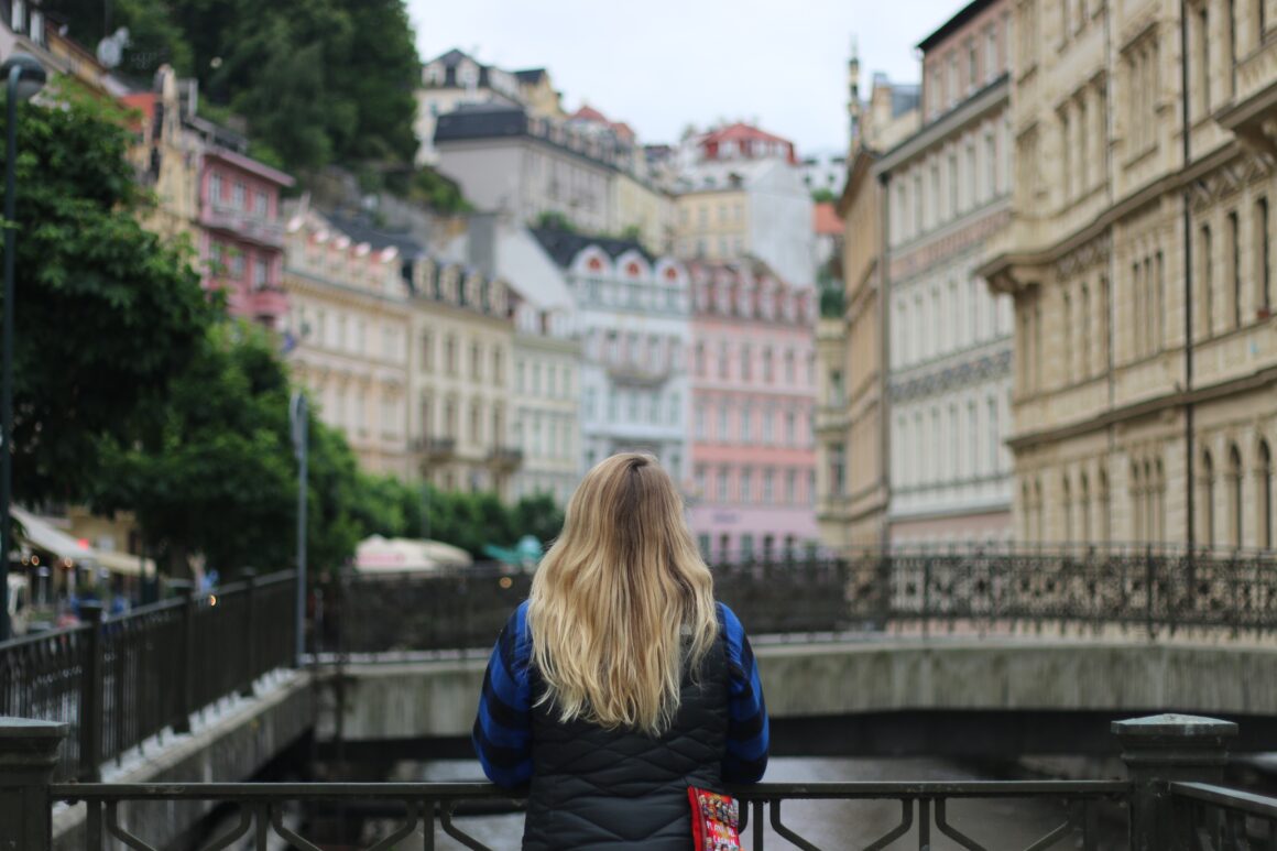 A girl looks out over Karlovy Vary, a small Czech town