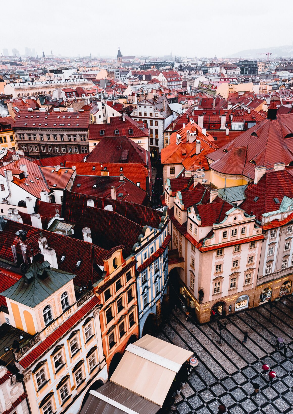 Colorful buildings tower above the narrow streets of downtown Prague