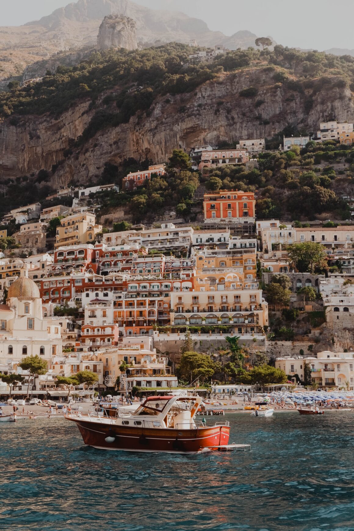 A boat floats in the water in the bay of Positano, Italy on the Amalfi Coast