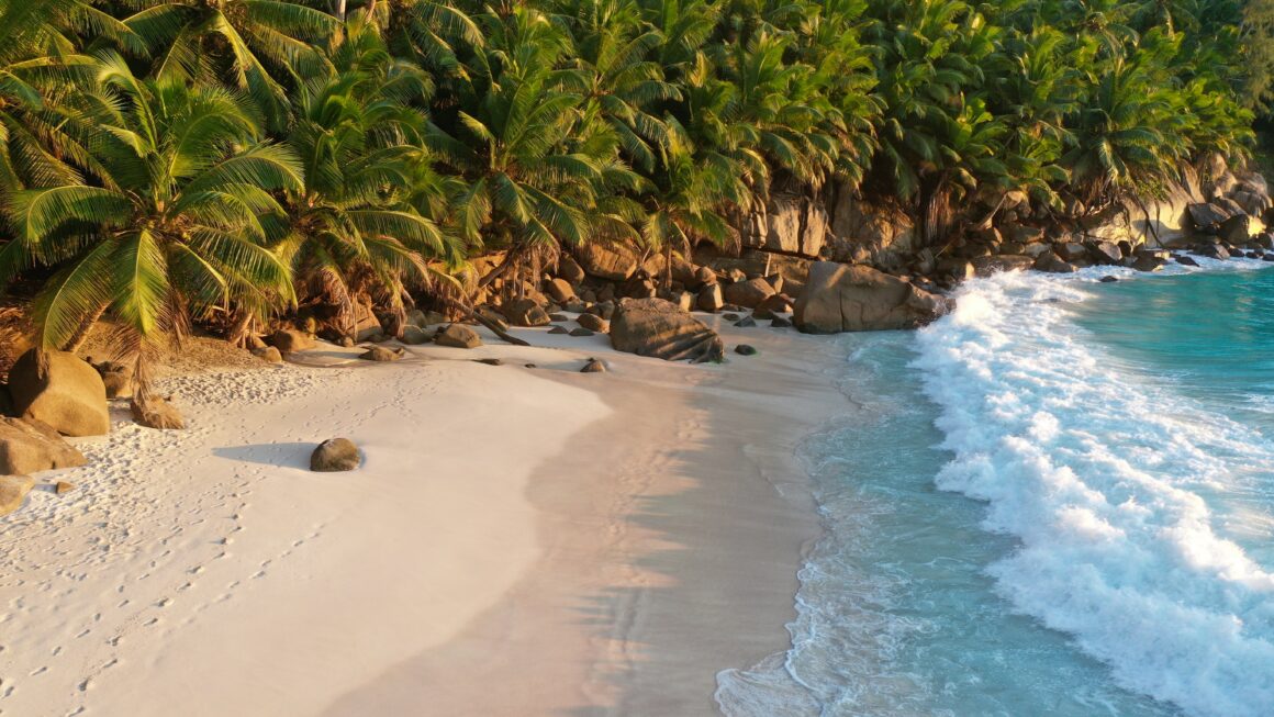 A rocky beach with crystal blue water on the Seychelles Island of Praslin
