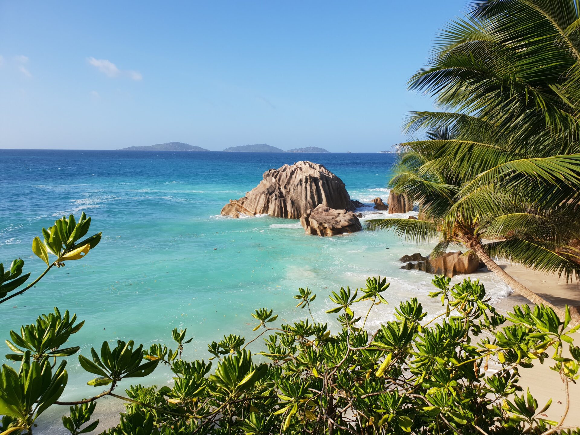 A rocky beach with crystal blue water on the Seychelles Island of La Digue