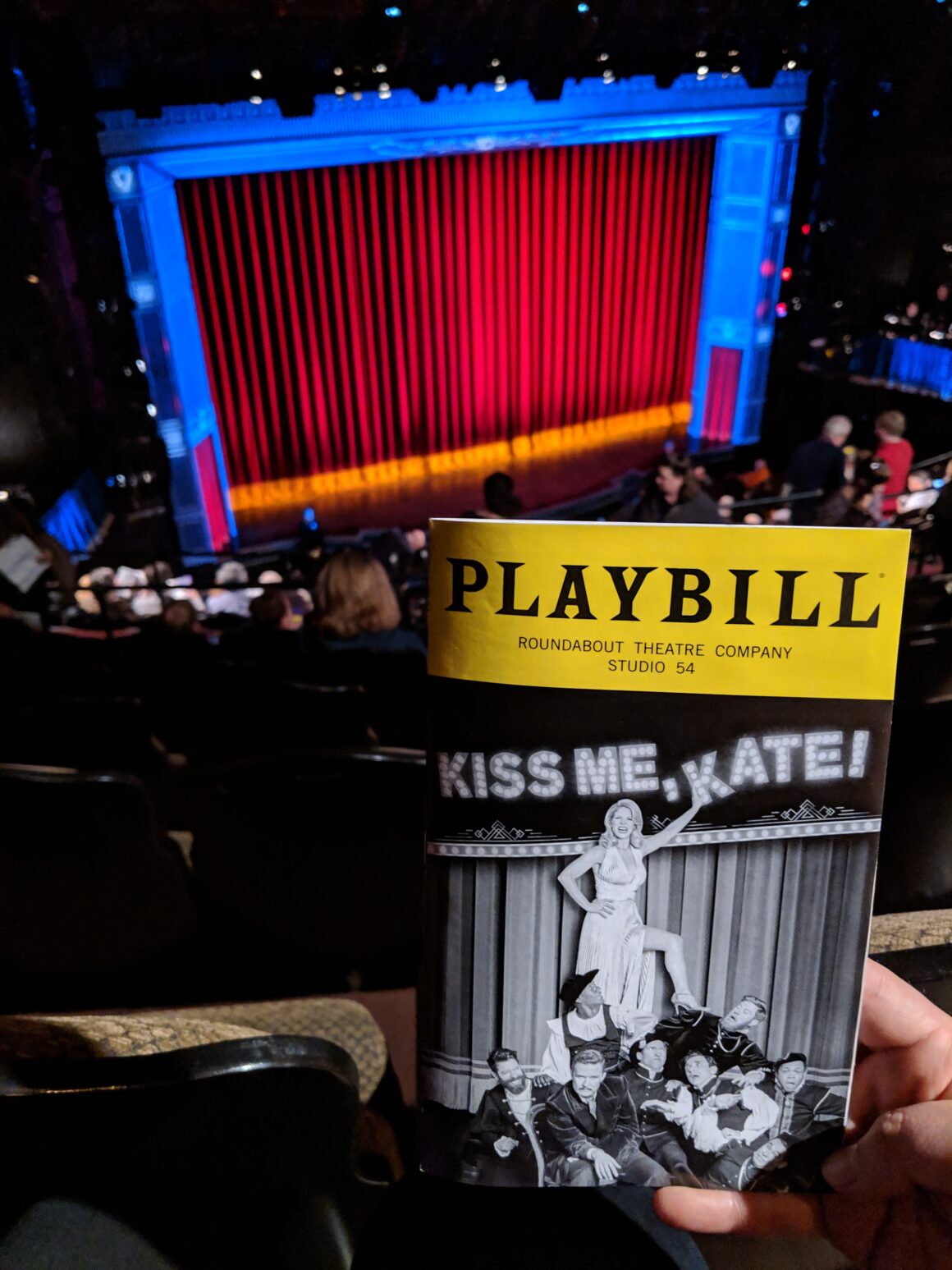A photo of the Kiss Me Kate playbill in front of the Broadway stage during a solo Broadway show outing