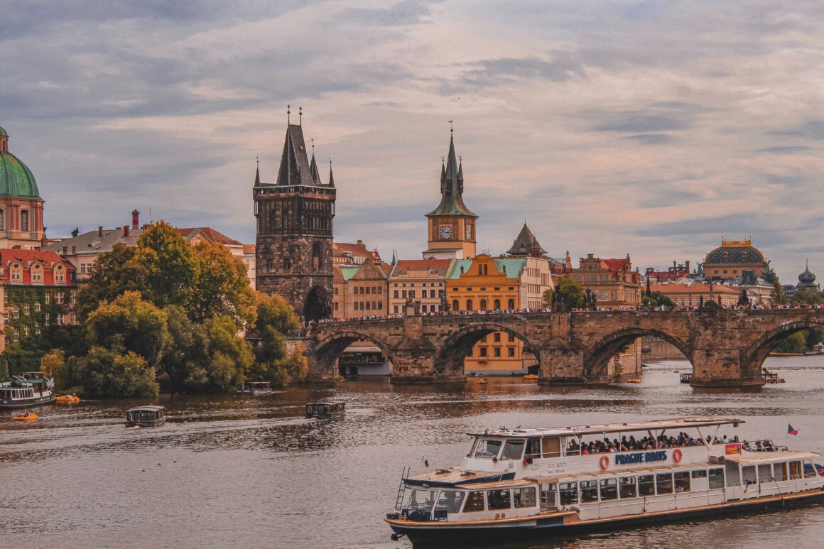 A boat cruises on the Vltava River in Prague, one of the best things to do in Prague