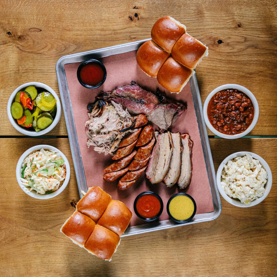 Barbecue meats and sides spread out on a silver tray at Big Smokers, one of the best restaurants in Prague