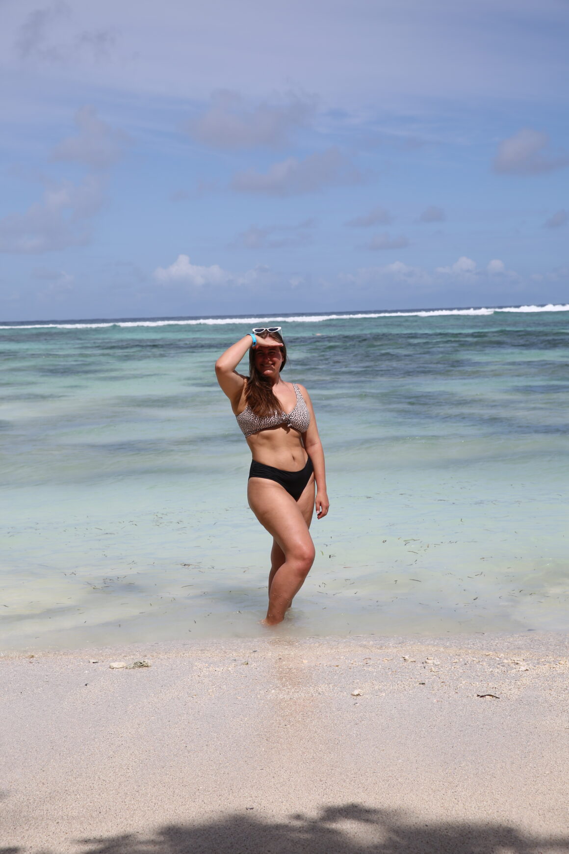 A woman poses on Anse Source D’Argent, one of the best things to do in the Seychelles