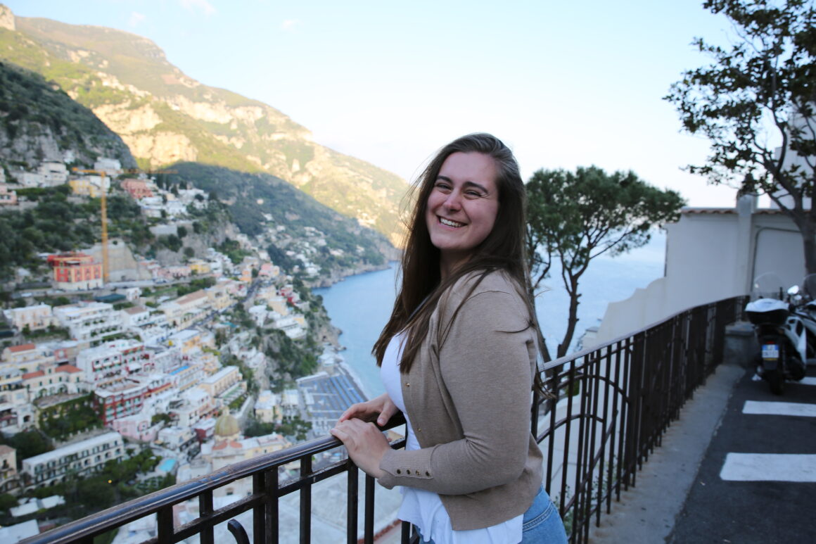 A girl poses in front of a POsitano View, one of the best things to do in Positano