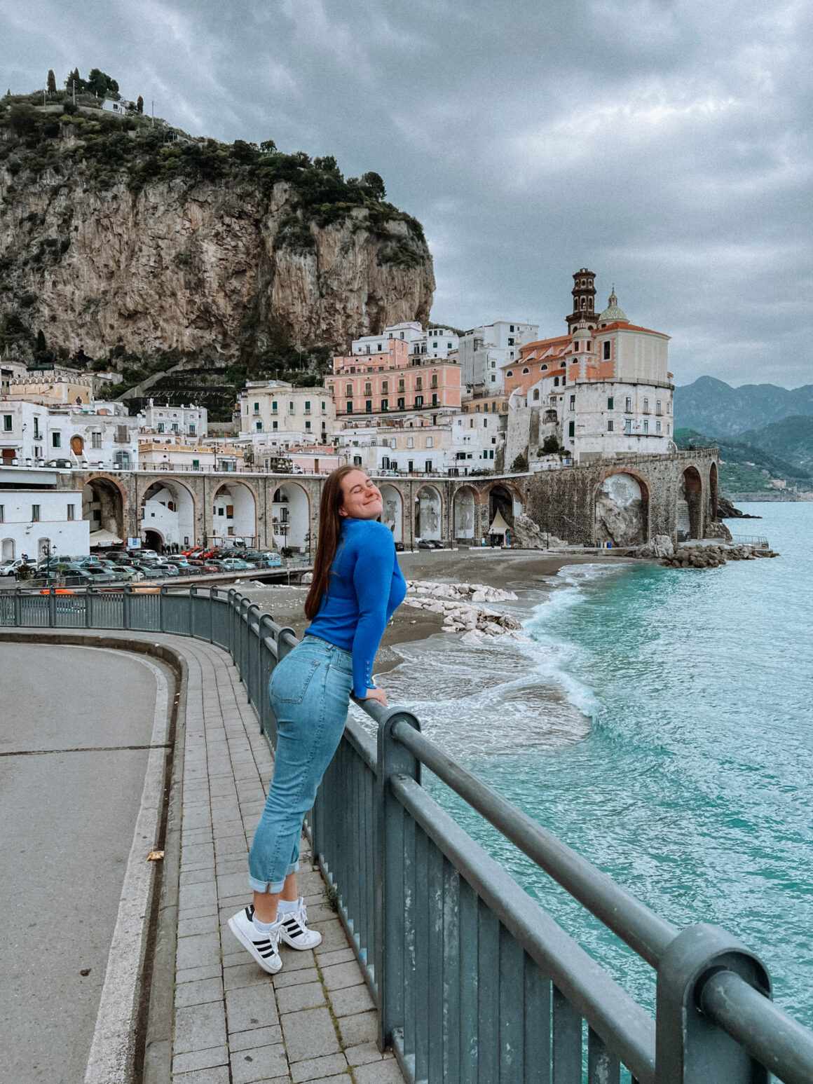 A girl poses in Amalfi, one of the best things to do in Positano
