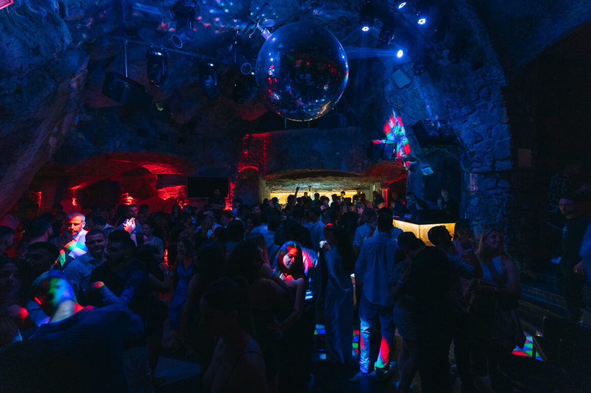 People dance at Music on the Rocks, a Positano nightclub, one of the best things to do in Positano