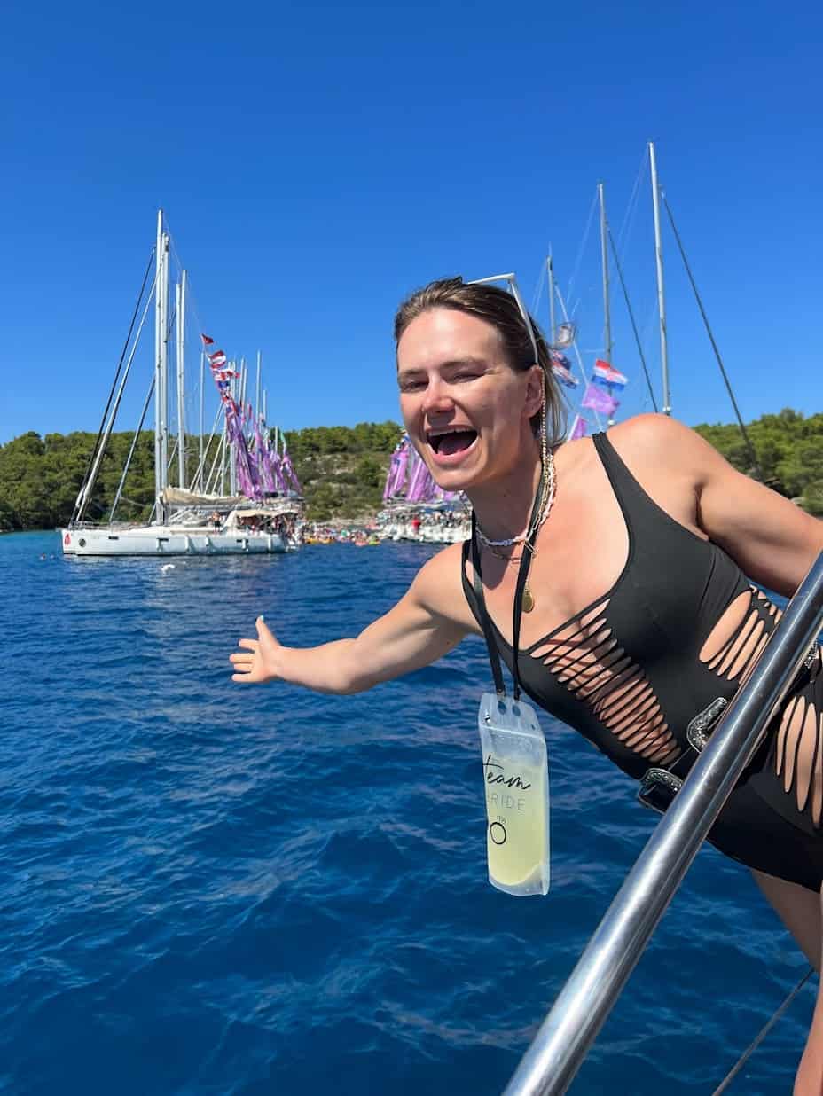 A girl hangs off a boat during Yacht Week Croatia