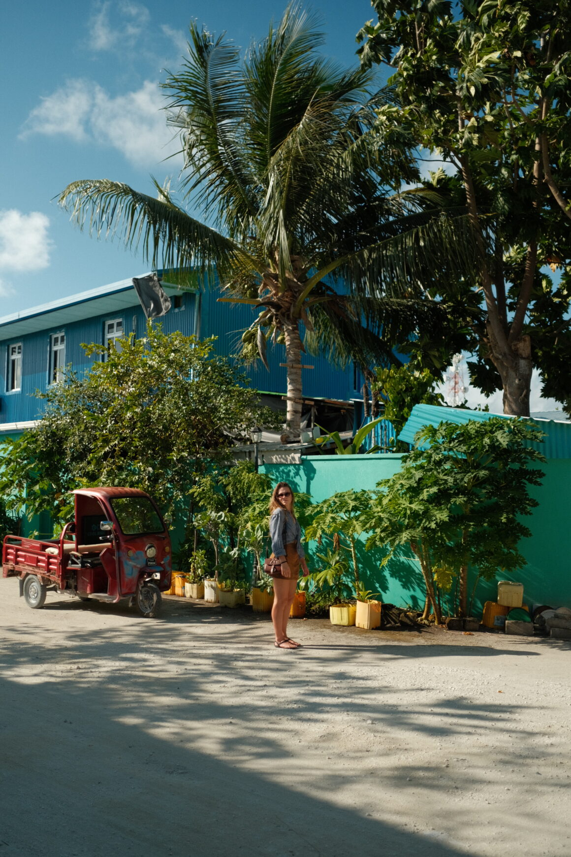 A smiling girl walking  in Dharavandhoo, one of the most beautiful local islands in the Maldives