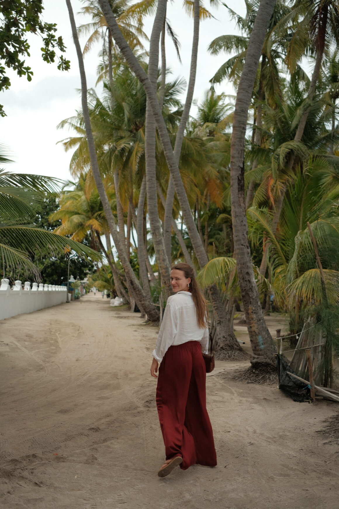 A smiling girl walking in Kendhoo, one of the most beautiful local islands in the Maldives