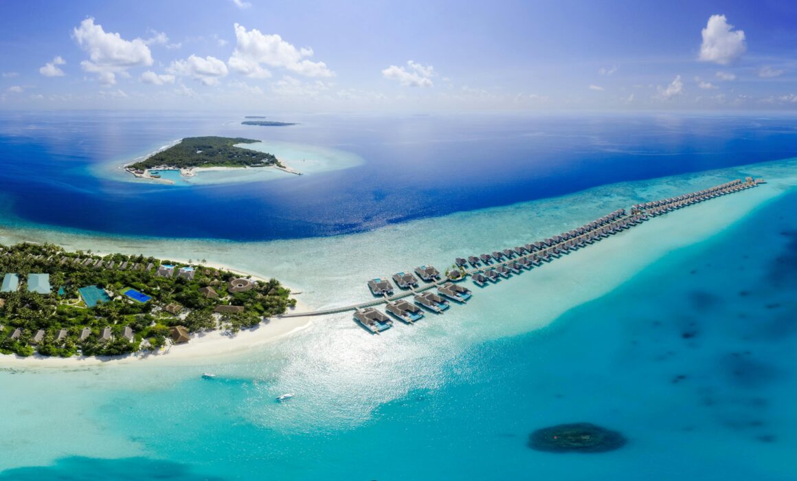 An aerial view of a Maldives resort with overwater bungalows