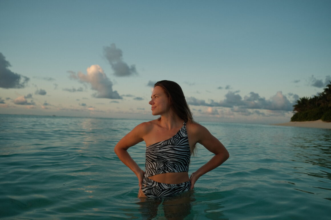 A girl on the beach in the Maldives, one of the safest beach destinations in the world