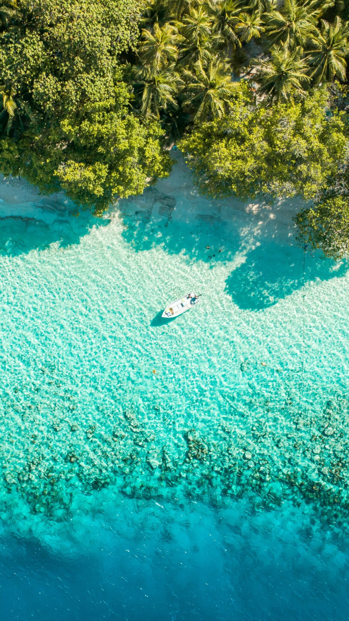 Sandy beach chairs on a local island in the Maldives, perfect to visit the maldives on a budget