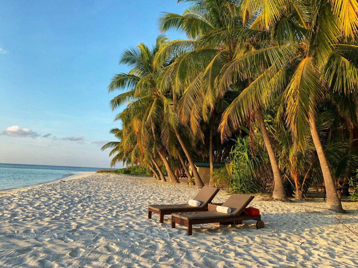 Sandy beach chairs on a local island in the Maldives