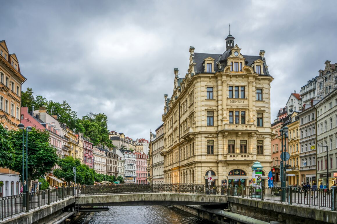 The colorful historic buildings facing the river in Karlovy Vary, one of the best places to visit in Czech Republic