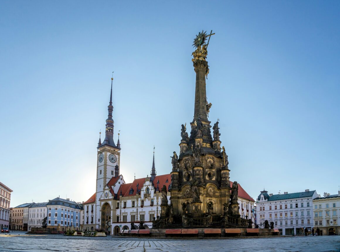 The historic town center of Olomouc, featuring a large central statue, one of the best places to visit in Czech Republic