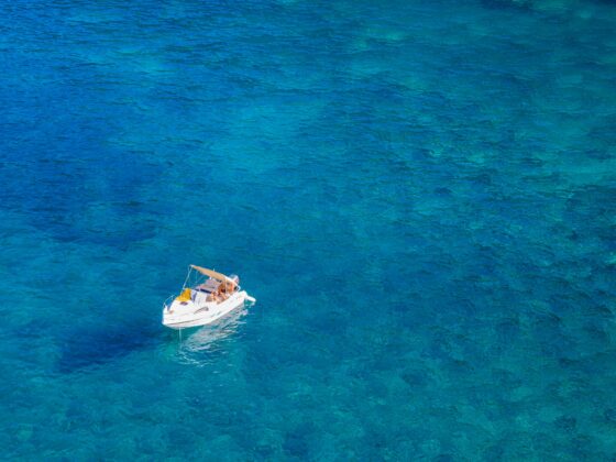 A boat floats on the water in Mallorca, one of the best things to do in Mallorca