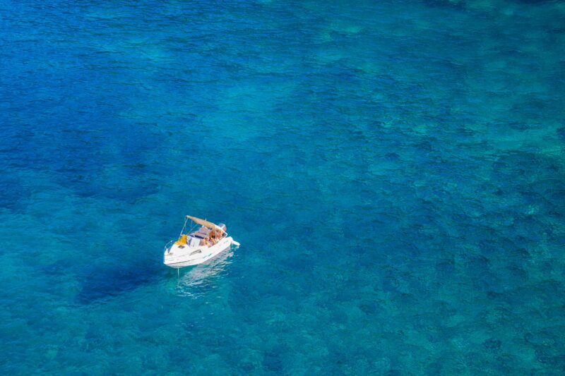 A boat floats on the water in Mallorca, one of the best things to do in Mallorca