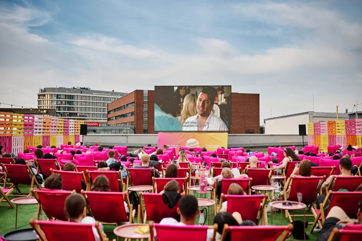 Chairs face an open air cinema on a Prague rooftop, one of the most unusual things to do in Prague